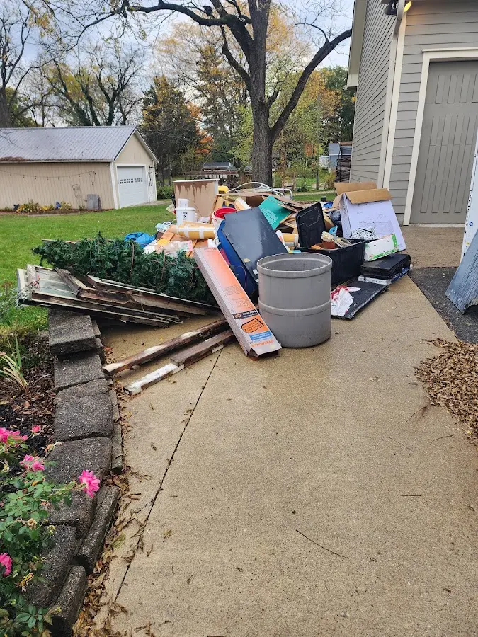 Dumpster being loaded with debris for Roofing Dumpster Rental in Chamblee